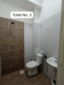 a small bathroom with a toilet and a sink at Homestay AinulZahra- For Malays Only in Seri Iskandar +14 photos