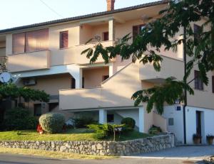 a large white building with a stone wall at Studio Apartment MD in Roč