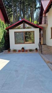 a house with a large driveway in front of it at Vila Cantacuzino in Buşteni