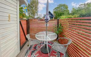 a table and two chairs with an umbrella on a balcony at Lovely Apartment In Borgholm With Wifi in Borgholm +6 photos