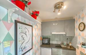 a small kitchen with a counter and a microwave at Lovely Apartment In Borgholm With Wifi in Borgholm