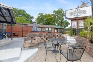 a patio with a table and chairs in front of a restaurant at Panacea Boathaus Lodge - Perfect Location for your lake vacation in Kimberling City