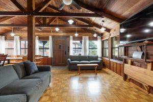 a living room with two couches and a tv at Panacea Boathaus Lodge - Perfect Location for your lake vacation in Kimberling City