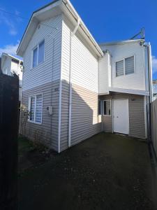 a white house with a garage at Brisas de Puerto Varas in El Cerrillo