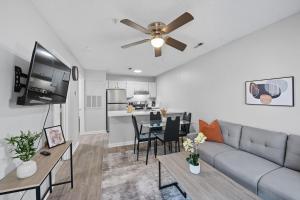 a living room with a couch and a table at Cozy Contemporary Stay I Pool & Gym I Free Parking in Spring Lake