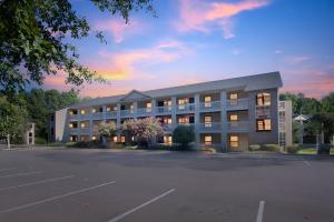 Un edificio con un estacionamiento enfrente. en Near Fort Liberty Modern 1br I Free Parking I Gym, en Spring Lake