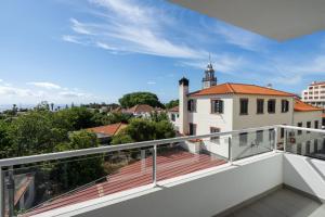 a balcony with a view of a city at Madeira Ocean View Pool and Comfort in Caniço in Caniço