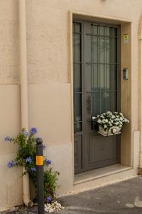 a gray door with two potted plants on it at La Suite del Faso in Fasano