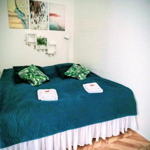 a bed with two towels on top of it at Apartament Mickiewicz - Center in Słupsk