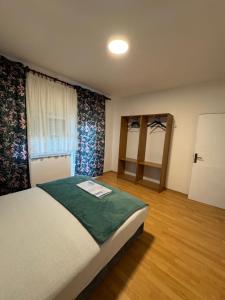 a bedroom with a large bed and a window at Kuća za odmor Nikola Medjugorje in Čitluk