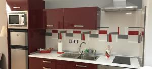 a kitchen with a sink and a microwave at Eduval in Yaiza