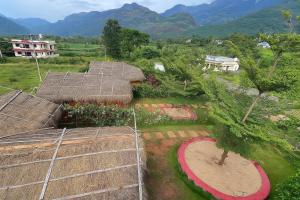 an overhead view of a house with a grass roof at Mannora Resorts Marayoor in Maraiyūr