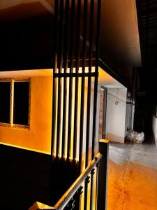 a hallway with a black railing and a window at Vibes stay in in Hyderabad