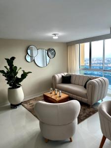 a living room with a couch and a table and chairs at Luxur Skyline Germania en Bucaramanga in Estación El Salto