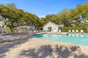 una piscina con sillas y una casa en New Listing! Pelican Bay 14 -Luxury Home at Beach!, en Isle of Palms