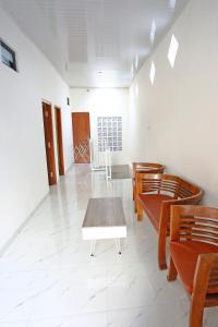 a room with wooden chairs and a table and a table at Mentari Homestay in Sentool