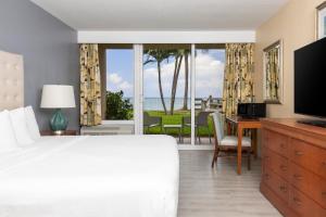 a bedroom with a bed and a view of the ocean at Ocean Breeze Inn Vero Beach in Vero Beach