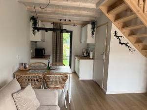 a kitchen and living room with a table and chairs at Mamma Mia Park in Łukęcin