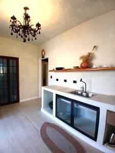 a kitchen with a sink and a counter at Suíte Casal no Centro - Jardim Secreto in Guararema +6 photos