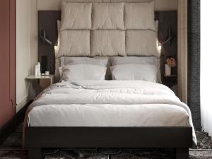 a bedroom with a large bed with white sheets and pillows at Grand Hotel des Brotteaux Lyon Ctre - Handwritten Collection in Lyon