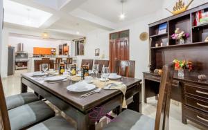 a kitchen and dining room with a table and chairs at Villa Cashew Diani in Diani Beach