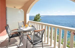 a balcony with a table and chairs and the ocean at One-Bedroom Apartment In Stanici in Celina +19 photos