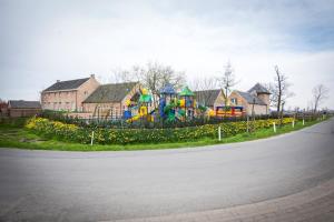 a park with a playground in the middle of a street at De Blauwe Hoeve in Zwijndrecht