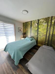 Una cama o camas en una habitación de Linda y cómoda casa individual en LLanquihue