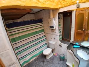 a small bathroom with a toilet and a sink at Casa relax in Coquimbo +17 photos