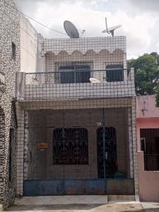 a building with a gate and a satellite at Quarto para solteiro perto do aeroporto e parques in Belém