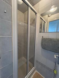 a shower with a glass door in a bathroom at Cadeby Lodge in Blackpool +25 photos