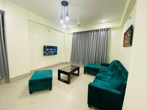 a living room with a couch and a table at CityLights Bashundhara Kensington Grand Collection in Dhaka