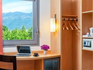 a laptop sitting on a desk in front of a window at Ibis Bursa in Bursa +69 photos