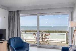 a living room with a view of the beach at Aldis - beachfront in Ostend