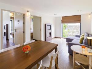 a living room with a table and a couch at Ibis Hua Hin in Hua Hin +76 photos