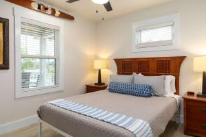 a bedroom with a bed and two windows at Lighthouse Lodge 1 in Kimberling City