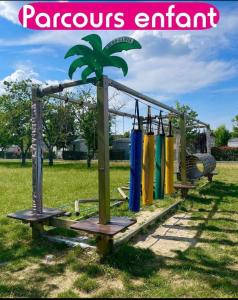 a playground with a palm tree on top of it at Mobile home 2chs 4à5 pers 32m2 promo fun pass sept in Onzain