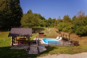 a swimming pool with a table and a gazebo at Vacation home Elizabeta in Slunj