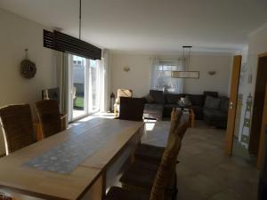 a living room with a table and a couch at Ferienhaus Ferienhof Behnke in Süssau +13 photos