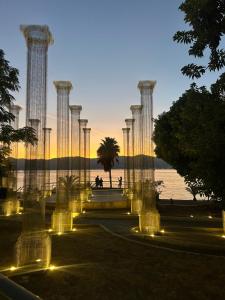 a row of columns with lights in front of the water at Casa di Eva in Reggio Calabria