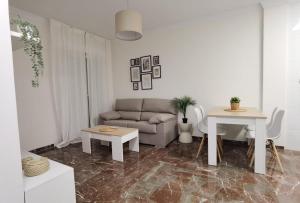 a living room with a couch and a table at Apartamento Luisa in Baena