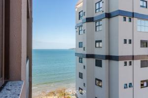 a view of the ocean from a building at Apartamentos Bem Equipados a 100 m da Praia - EVR in Perequê