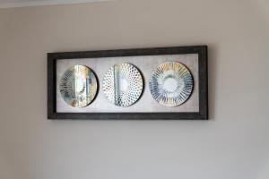 a framed picture of three plates on a wall at Departamento Calama in Calama +1 photo