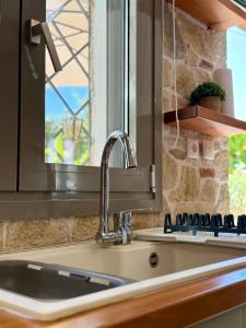 a kitchen with a sink and a window at Lena's House Schimatari in Skhimatárion +16 photos