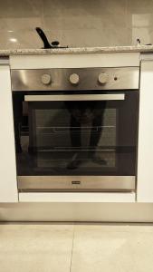 a microwave oven in a kitchen with its door open at LUXURY STUDIO SUITE By ALVISUITE in Lahore +29 photos
