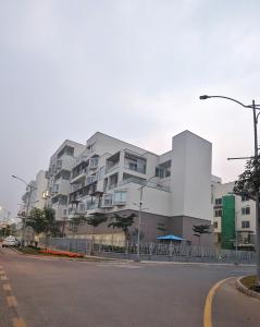 a large white building on the side of a street at LUXURY STUDIO SUITE By ALVISUITE in Lahore