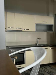 a kitchen with a sink and a microwave at napartmentss in Pristina