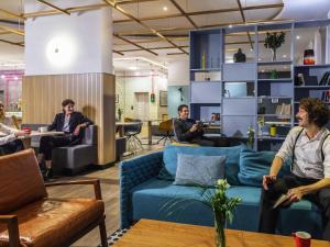 a group of people sitting in a living room at Aparthotel Adagio Berlin Kurfürstendamm in Berlin