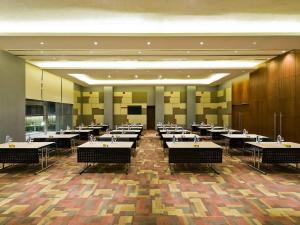 a large dining room with tables and chairs at ibis Nashik - An Accor Brand in Nashik