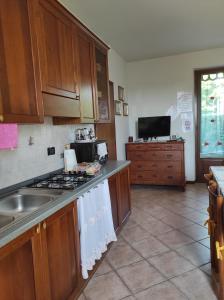 a kitchen with a sink and a stove top oven at Casa NONNA LINA in Medole